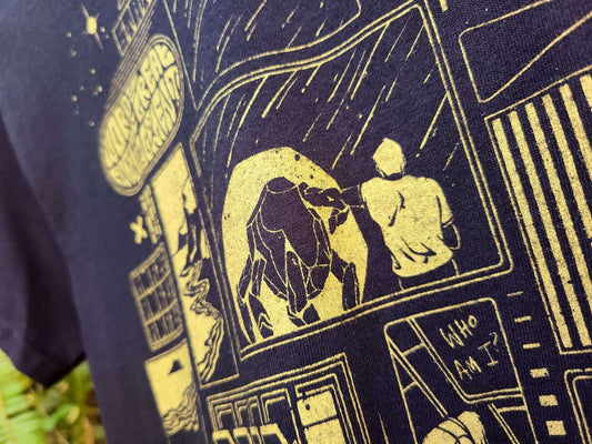 Close-up of a black t-shirt with gold screen printed ink featuring a comic-style image of Grace and Rocky from Project Hail Mry. 
