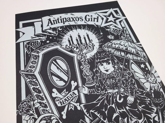 Black and white illustration of a doll with an umbrella and decorative elements, featuring the text 'Antipaxos Girl'.
