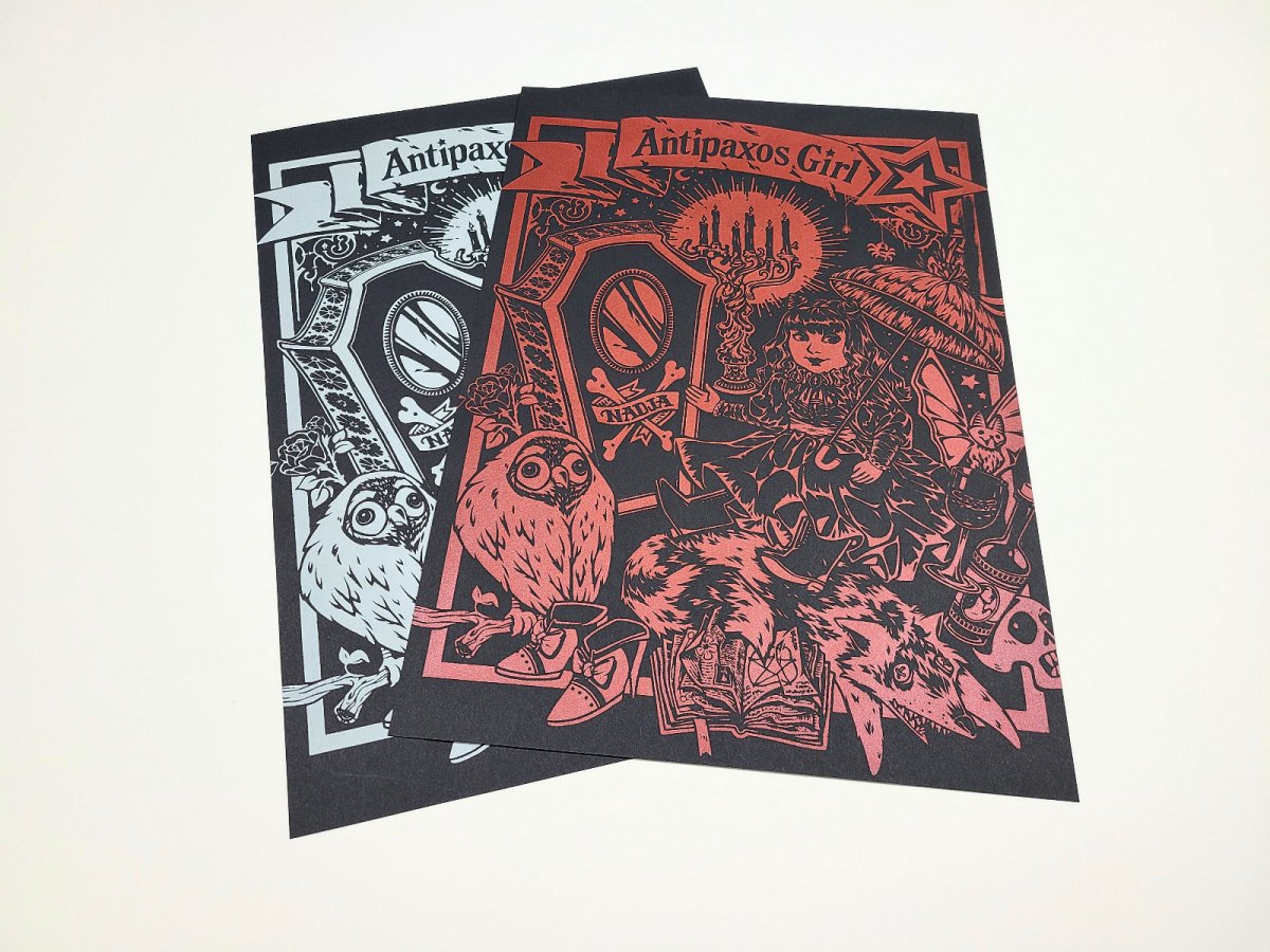 Two black and red posters with 'Antipaxos Girl' branding on a white background