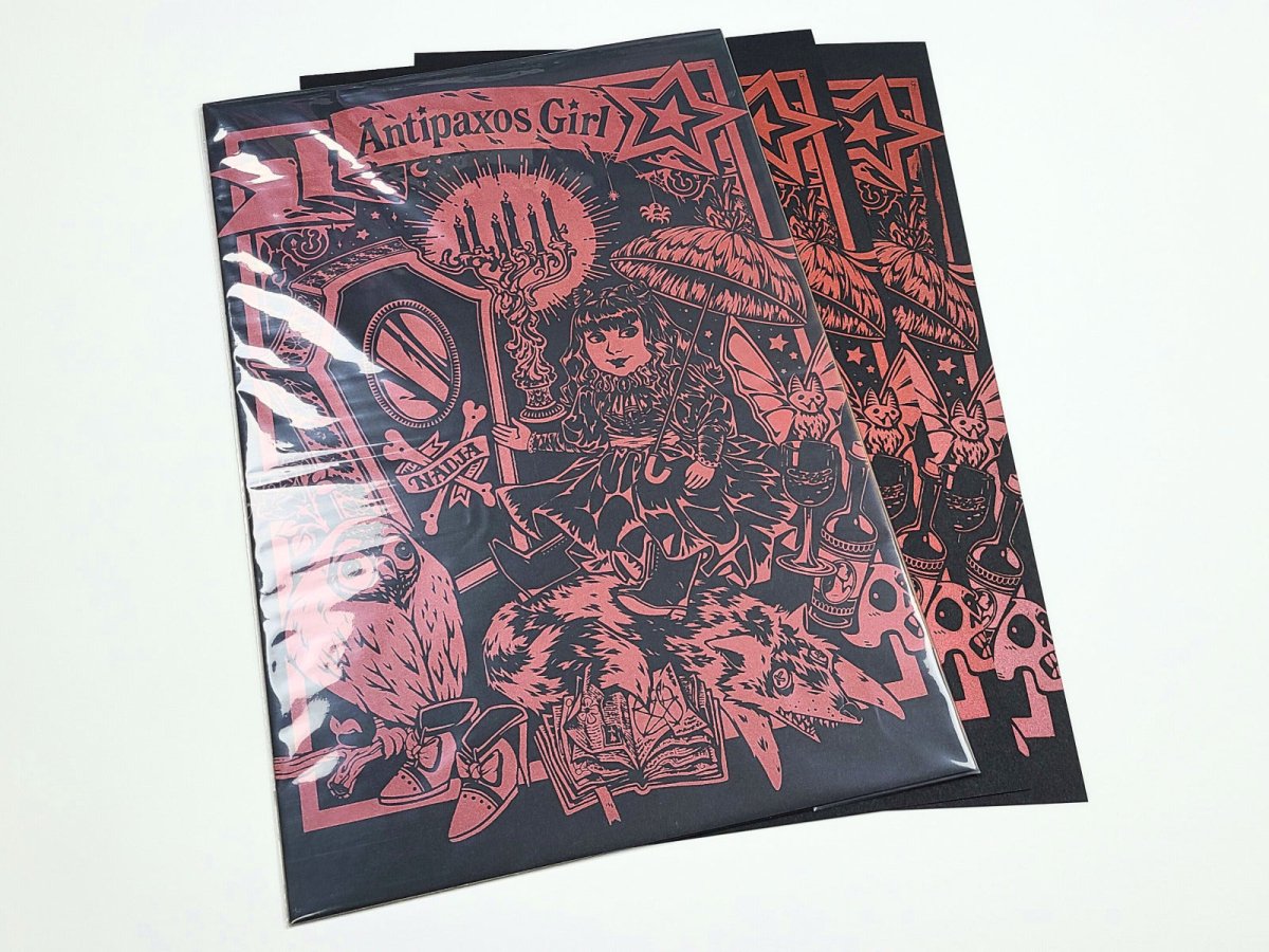 A graphic design of a nadja doll and text 'Antipaxos Girl' on a white background. 