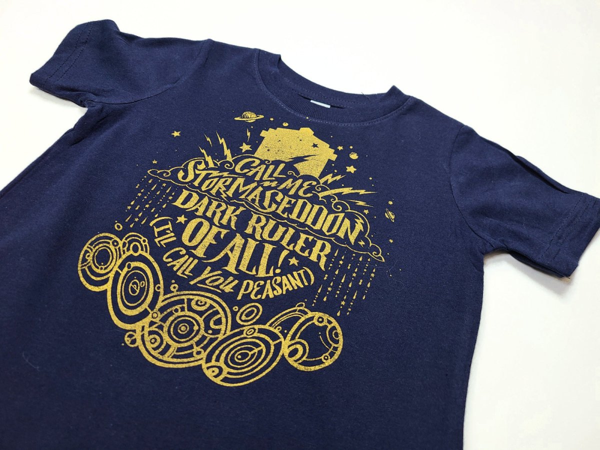 Navy blue toddler shirt with gold graphic design on a white background