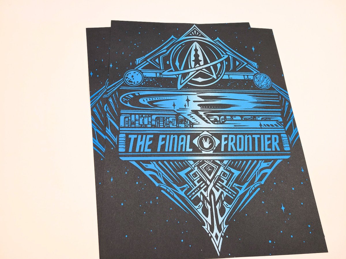Black poster with blue 'The Final Frontier' design on a beige background
