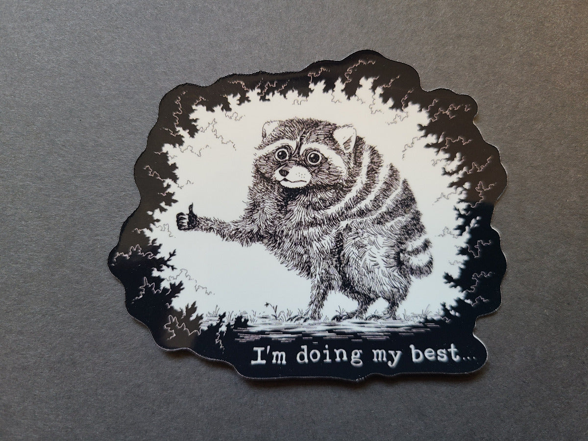 A die-cut sticker featuring a black and white illustration of Jimothy raccoon giving a thumbs-up, with the text 'I'm doing my best.