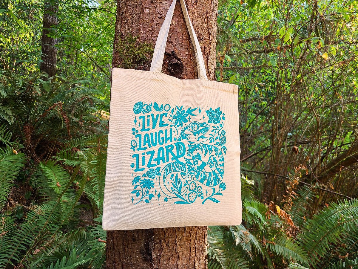 Peacock blue lizard tote bag with floral design, hand screen printed on cream cotton canvas.