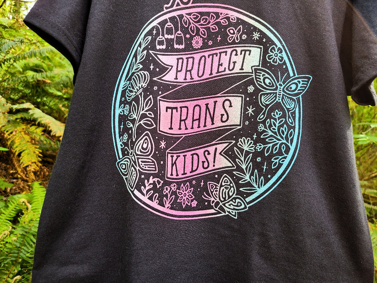 Black t-shirt with trans pride ombre gradient design, protect trans kids graphic tee